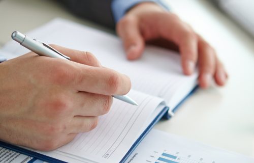 close-up-businessman-writing-summary