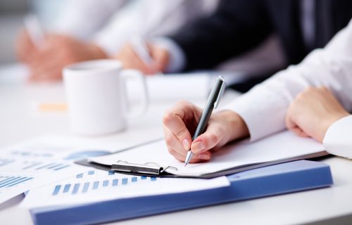 close-up-busy-businesswoman-writing